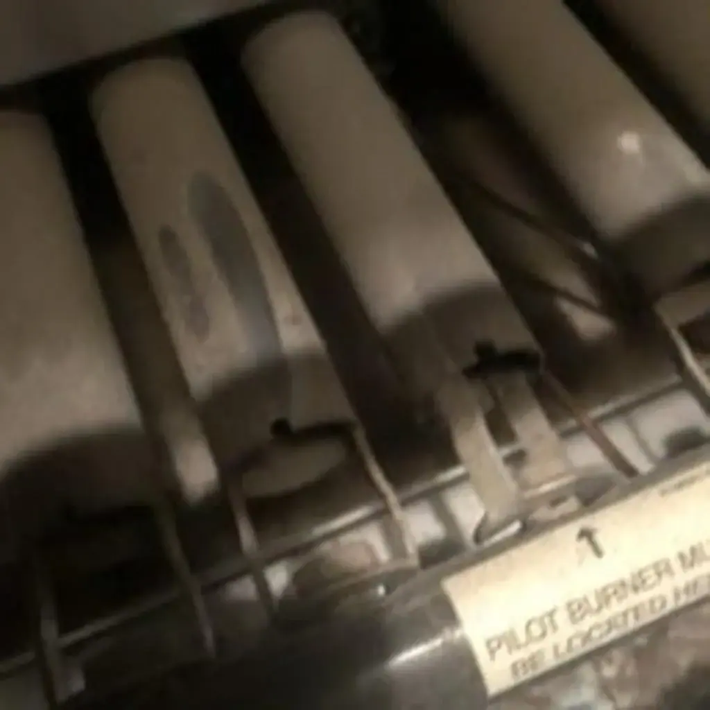 Close-up of gas furnace burners and pilot assembly inspected during a heating repair in White Plains, NY