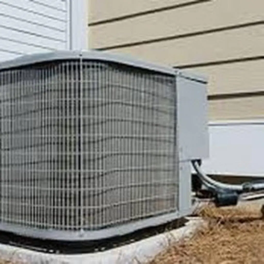 Older central air condenser against vinyl siding at a Westchester County, NY home